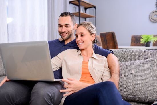 couple on laptop researching if selling their structured settlement before retirement is right for them