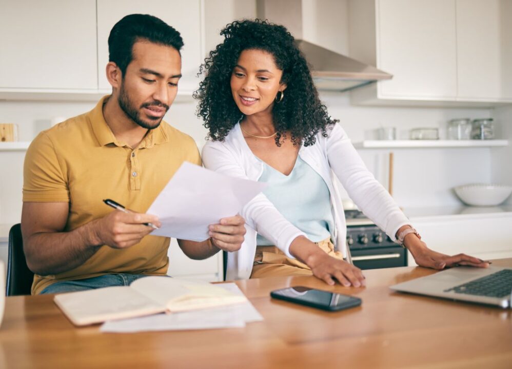 couple reviewing costs associated with selling structured settlement