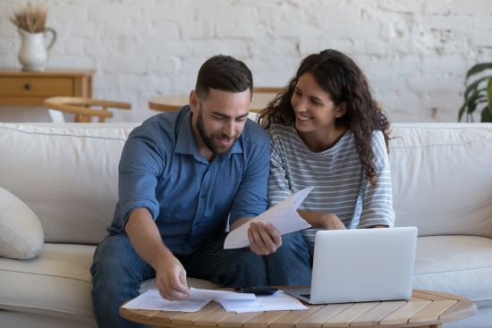 happy couple researching to sell annuity payments