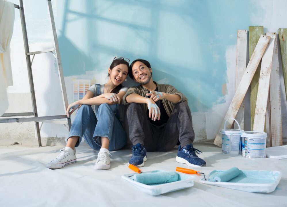 happy couple renovating home after selling structured settlement payments