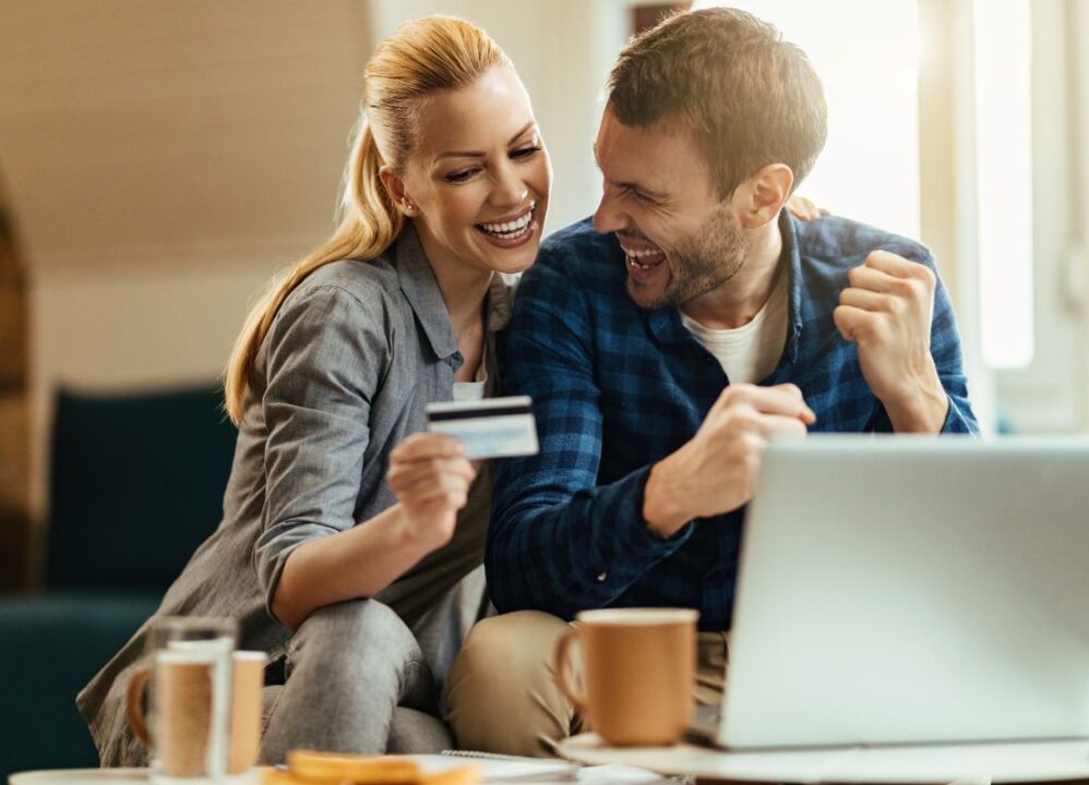 young couple on laptop researching ways to build their credit