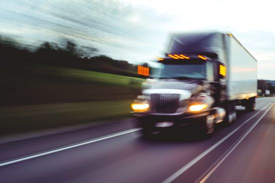 blurred image of a speeding truck on a highway, symbolizing the Tracy Morgan Walmart truck accident