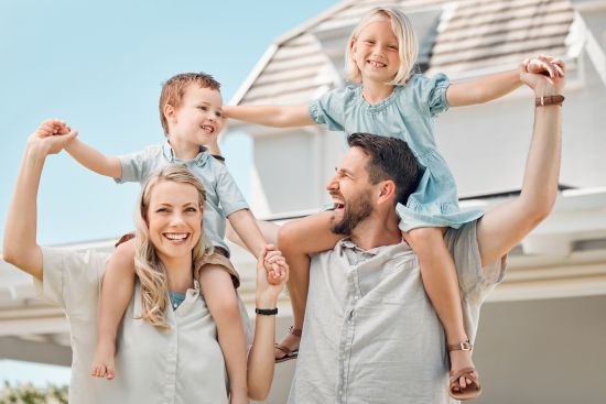 Happy family enjoying time together outdoors, symbolizing financial stability and support.