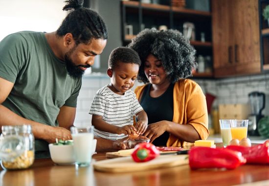 supportive family making meal in kitchen