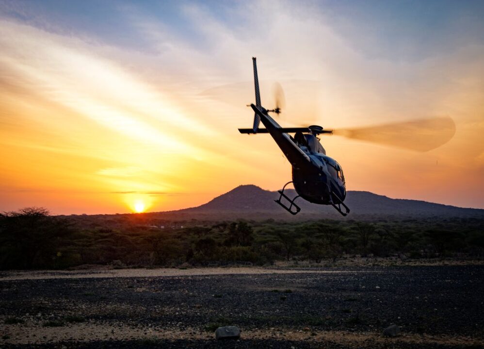 A helicopter flying into the sunset, symbolizing the tragic accident central to Vanessa Bryant's lawsuit settlement.